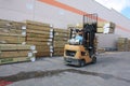 A monotonous job forklift driver loads lumber